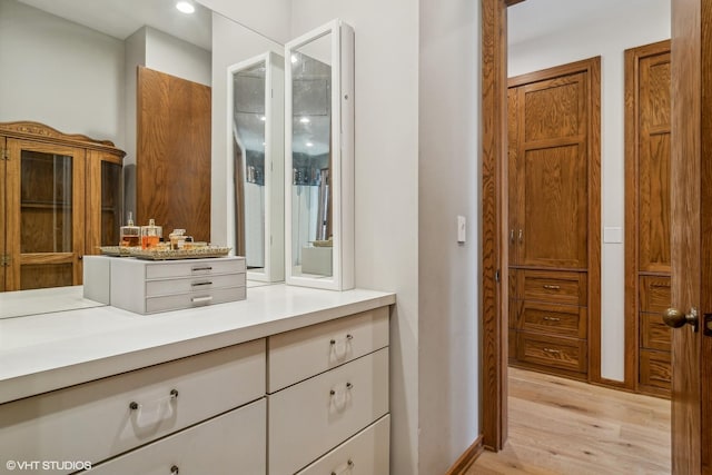 bathroom featuring hardwood / wood-style flooring and vanity