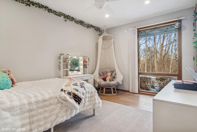 bedroom with ceiling fan and light hardwood / wood-style floors