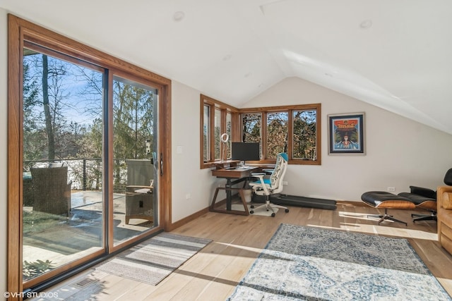 home office featuring vaulted ceiling and light wood-type flooring