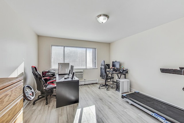 office space featuring light hardwood / wood-style flooring, a wall unit AC, and a baseboard radiator