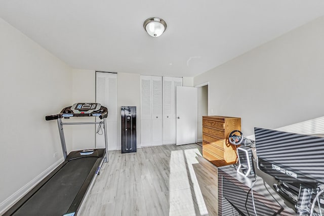 exercise room with light hardwood / wood-style flooring