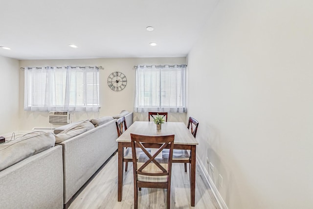 dining room featuring light wood-type flooring and cooling unit