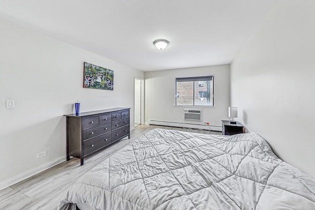 bedroom with an AC wall unit, baseboard heating, and light hardwood / wood-style flooring