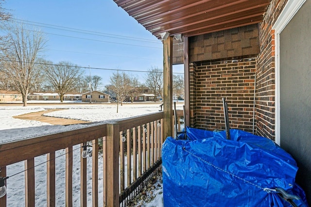 view of snow covered back of property