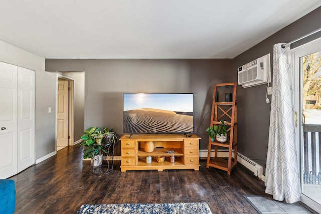 living area featuring a baseboard heating unit, dark hardwood / wood-style flooring, and a wall unit AC