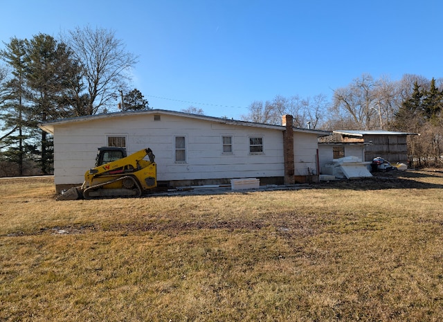 back of house with a lawn