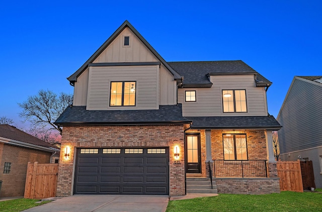 view of front of house with a garage and a lawn