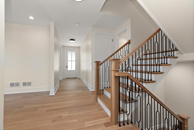 entrance foyer with recessed lighting, visible vents, baseboards, and wood finished floors