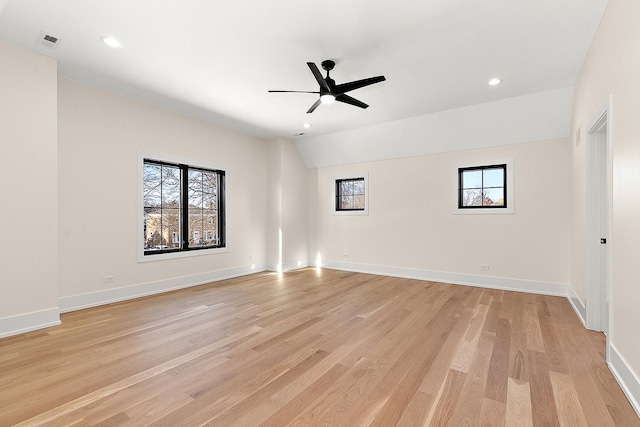 empty room with ceiling fan, light wood-style floors, and a healthy amount of sunlight