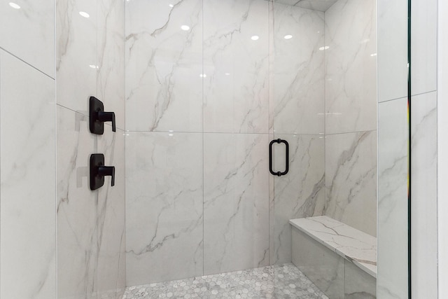 bathroom with a marble finish shower