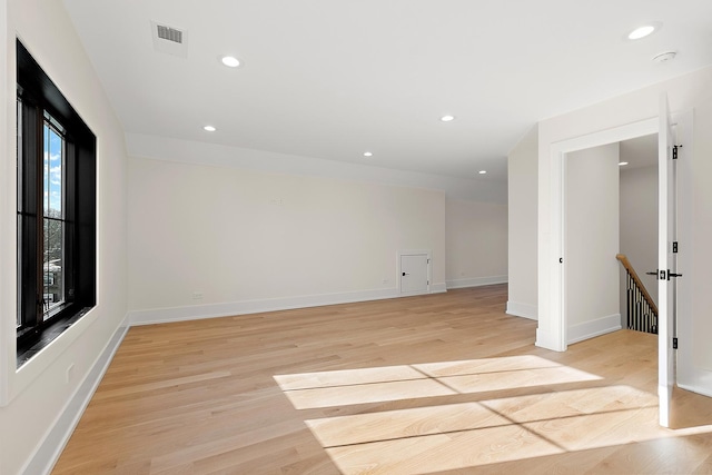 spare room with light wood-type flooring, baseboards, and recessed lighting