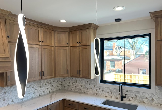 kitchen featuring a sink, a wealth of natural light, and decorative backsplash