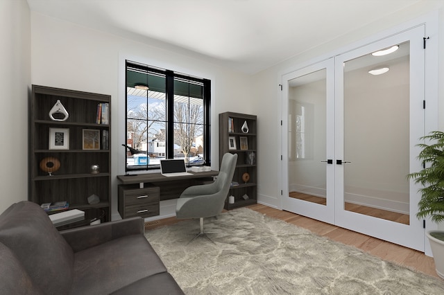 office space featuring french doors, baseboards, and wood finished floors