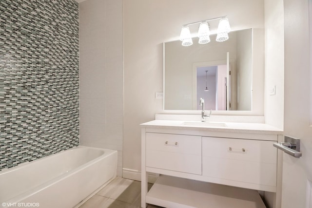 bathroom with tiled shower / bath combo and vanity