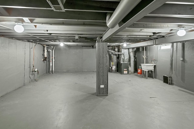 basement with water heater and heating unit