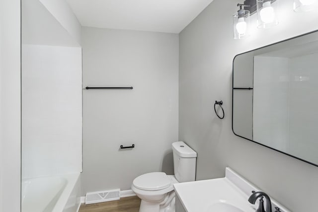 full bathroom with vanity, shower / bathing tub combination, hardwood / wood-style floors, and toilet