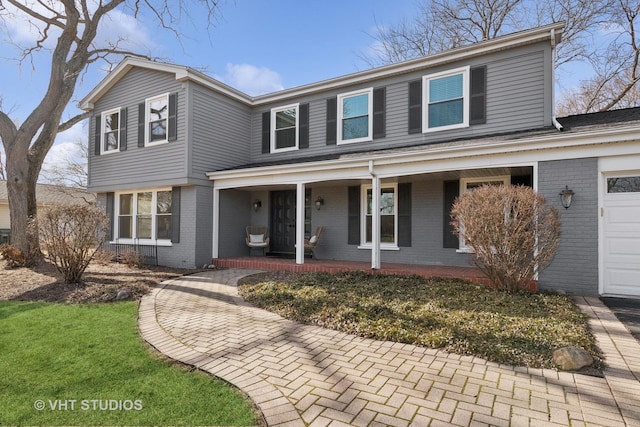 front of property with a garage and covered porch