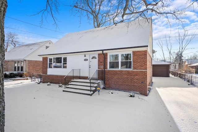 view of front of house with a garage and an outdoor structure