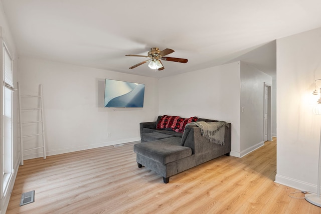 living area with light hardwood / wood-style flooring and ceiling fan