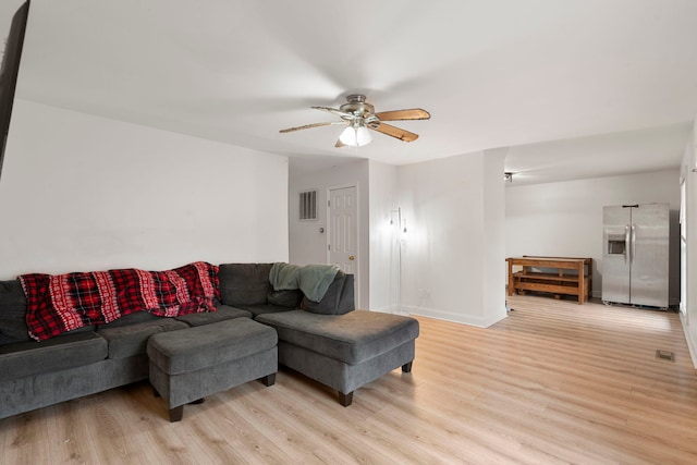 living room featuring ceiling fan and light hardwood / wood-style floors