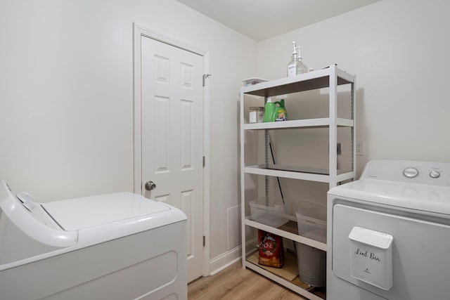 washroom featuring washer and dryer and light hardwood / wood-style floors