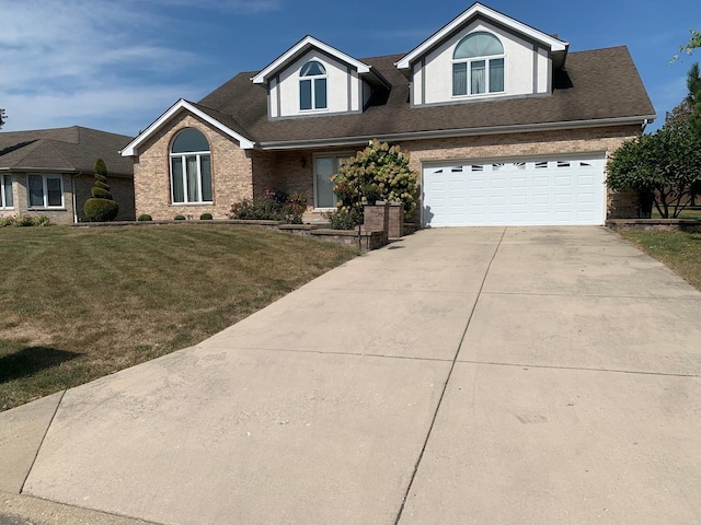 view of front of house with a garage and a front lawn