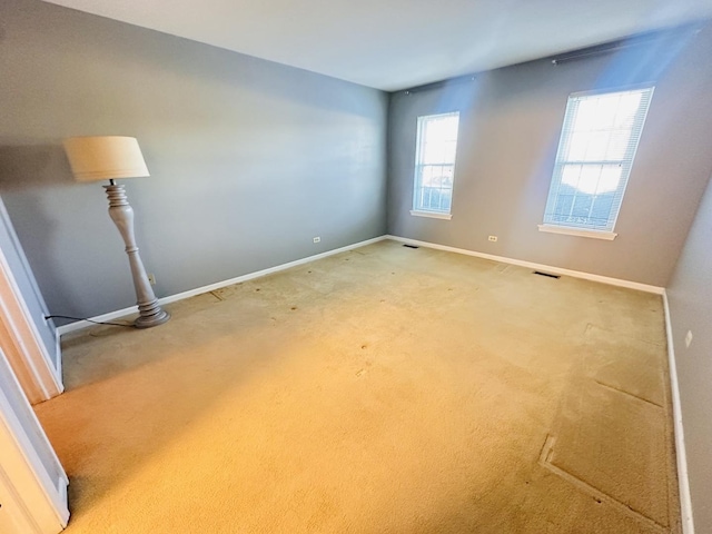 carpeted empty room with a healthy amount of sunlight