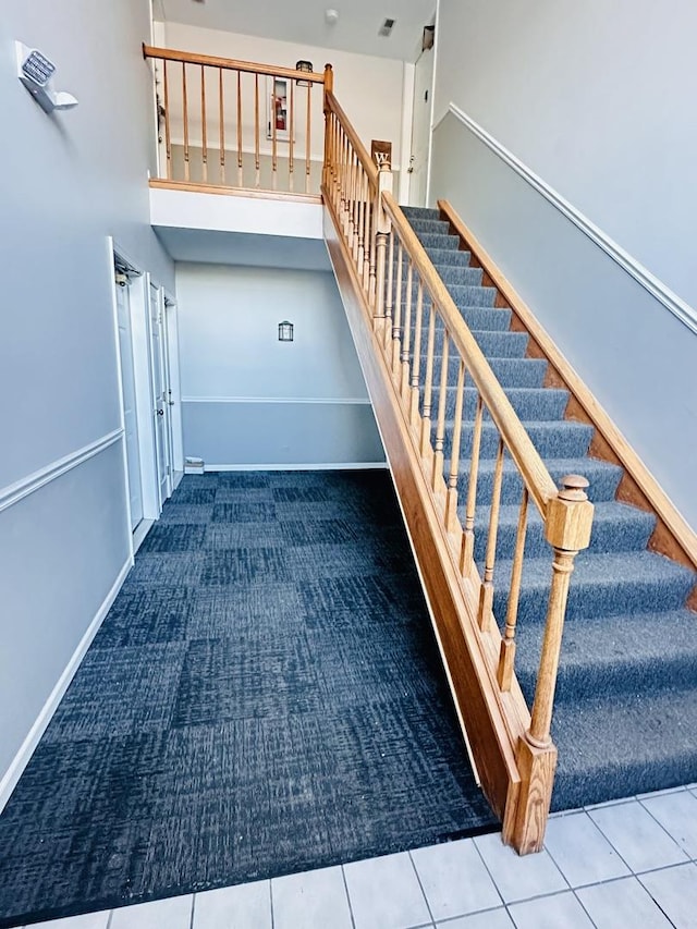 stairs featuring tile patterned floors