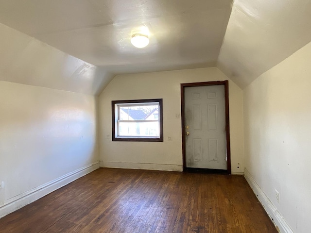 bonus room with dark hardwood / wood-style floors and lofted ceiling