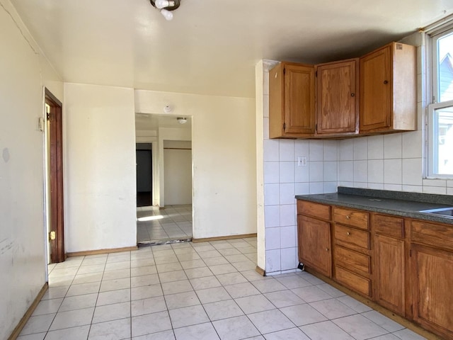 kitchen with decorative backsplash and light tile patterned floors