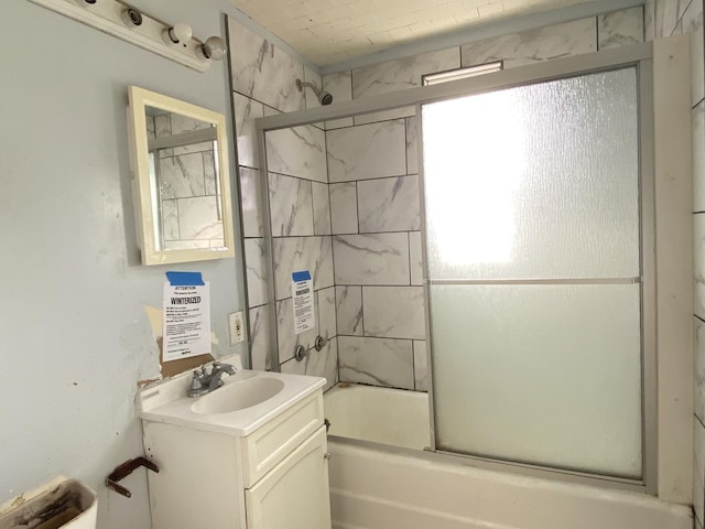 bathroom featuring shower / bath combination with glass door and vanity