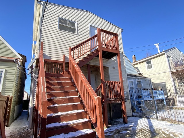 view of snow covered rear of property