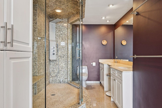 full bathroom featuring a stall shower, vanity, toilet, and baseboards