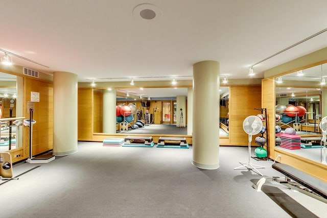 exercise room with rail lighting and visible vents