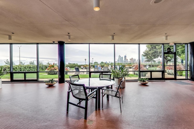 sunroom featuring a view of city and a wealth of natural light