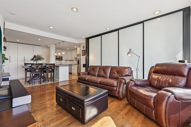 living area featuring recessed lighting and light wood-style flooring