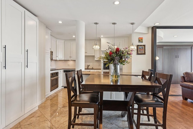 dining space featuring recessed lighting