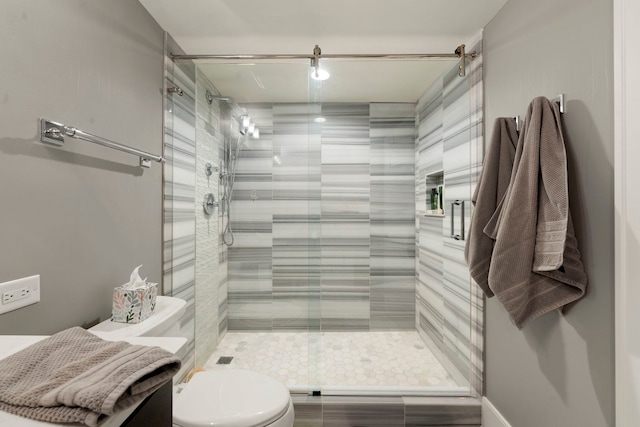 bathroom featuring an enclosed shower and toilet