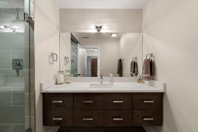 bathroom with tile patterned flooring, vanity, and an enclosed shower