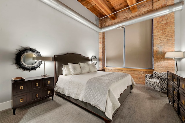 bedroom featuring beam ceiling, wood ceiling, carpet floors, and brick wall