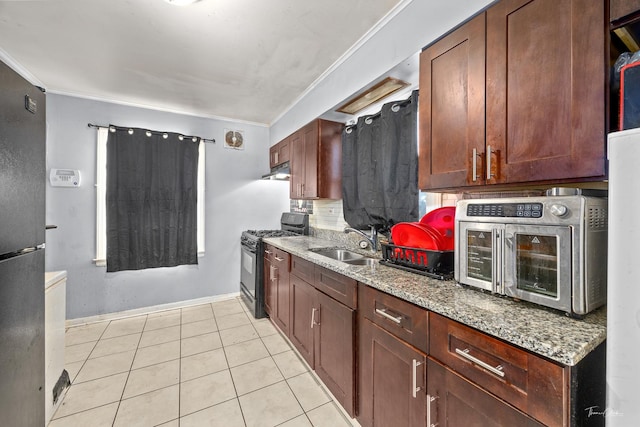 kitchen featuring light tile patterned flooring, sink, light stone counters, and black appliances