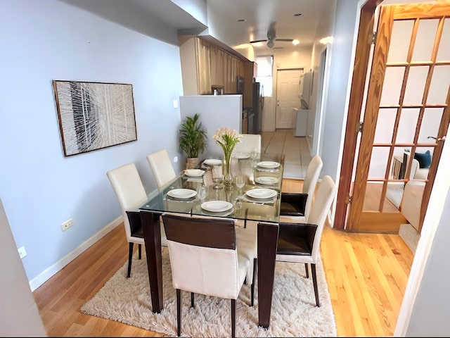 dining area with ceiling fan and light hardwood / wood-style flooring