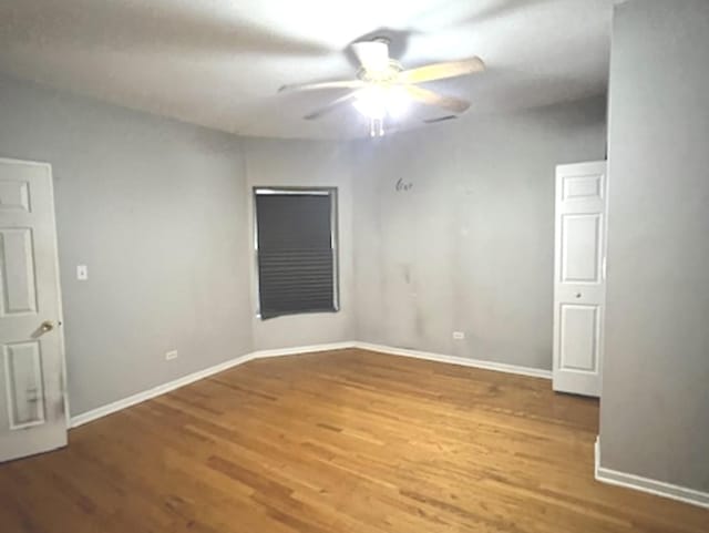 unfurnished room featuring ceiling fan and hardwood / wood-style floors