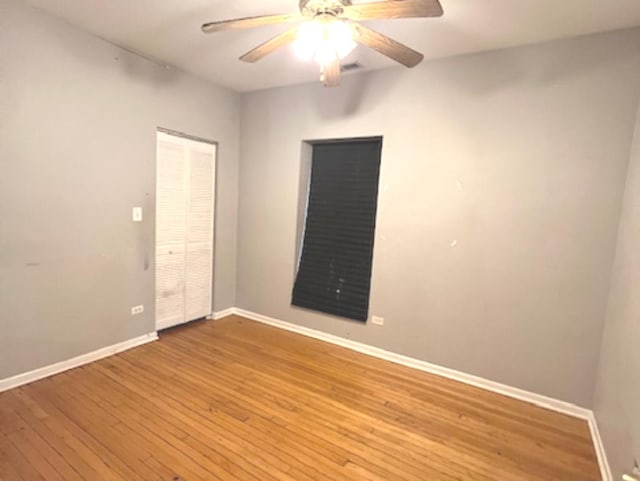 unfurnished room with hardwood / wood-style flooring and ceiling fan