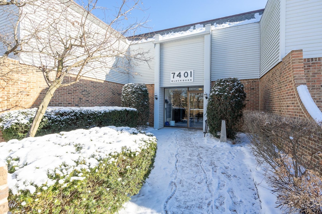 view of snow covered property entrance