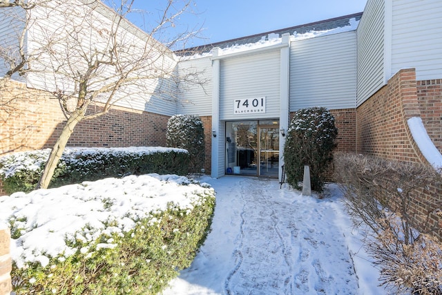 view of snow covered property entrance