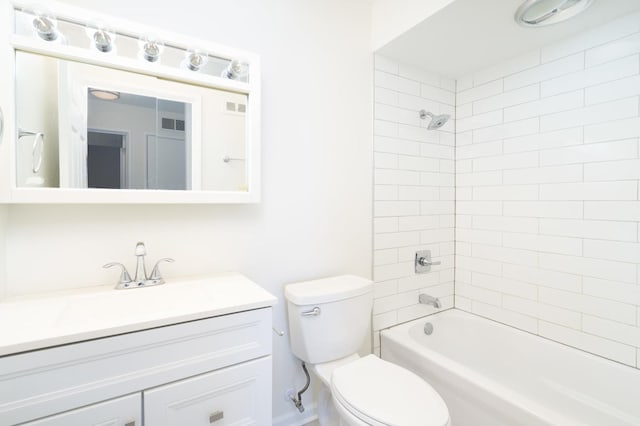 full bathroom with toilet, vanity, and tiled shower / bath