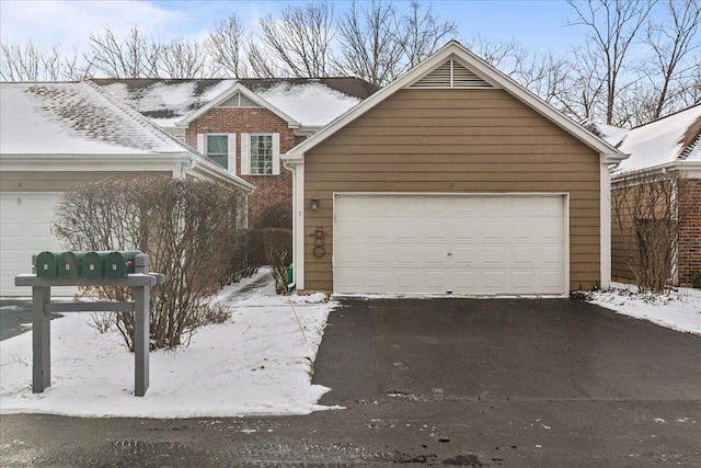 view of front of home featuring a garage and an outbuilding