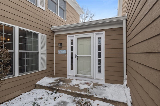 view of snow covered property entrance