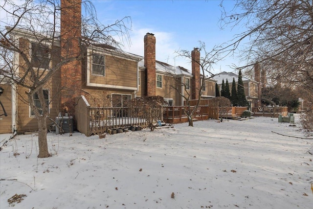 snow covered property featuring a wooden deck